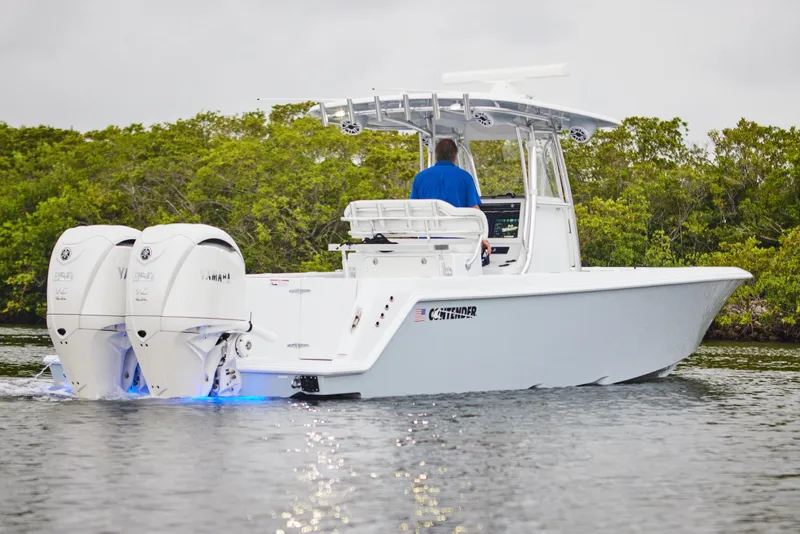 Slide: The Image of 2026 Contender 32 ST boat with dual Yamaha engines on calm water. - 12