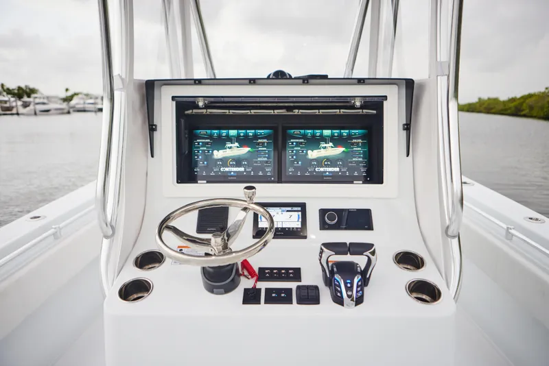 Slide: The Image of 2026 Contender 32 ST boat dashboard with dual screens and modern controls. - 15