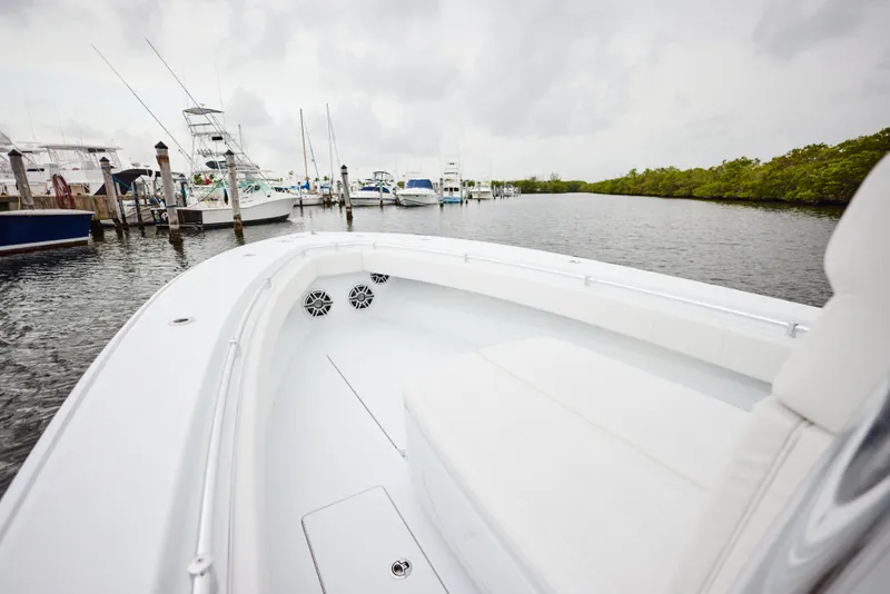 Slide: The Image of 2026 Contender 32 ST boat docked in a marina, featuring sleek white design. - 17
