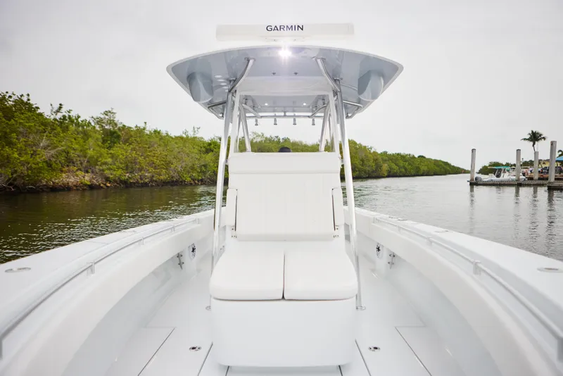 Slide: The Image of 2026 Contender 32 ST boat with Garmin equipment on a calm waterway. - 18