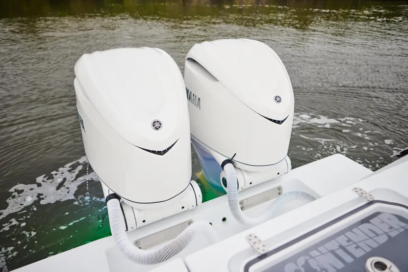 Slide: The Image of Twin Yamaha outboard engines on a 2026 Contender 32 ST boat in water. - 19