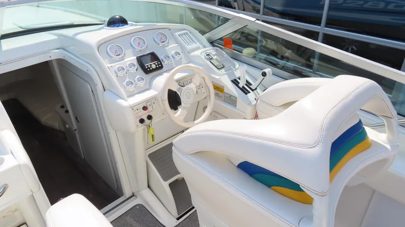 Slide: The Image of Interior of a 2000 Formula Fastech boat with white seating and control panel. - 13