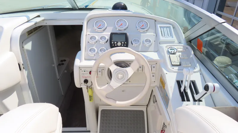 Slide: The Image of Cockpit of a 2000 Formula Fastech boat with steering wheel and control panel. - 14