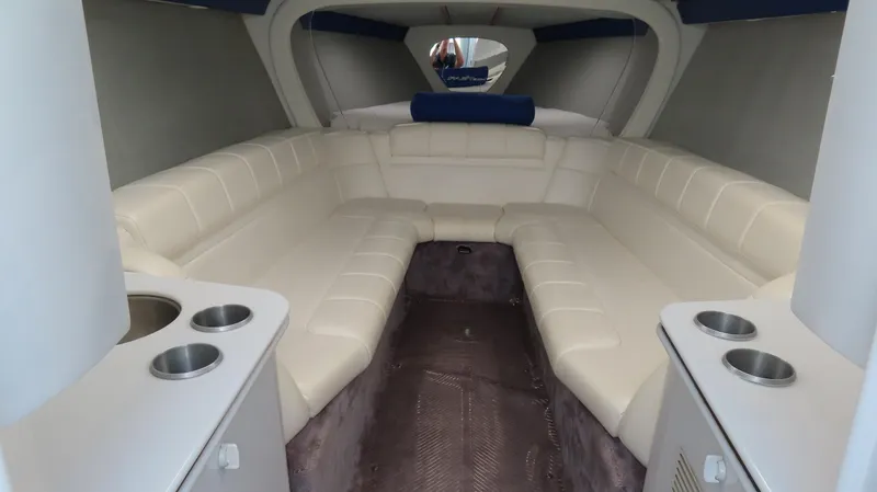 Slide: The Image of 2000 Formula Fastech boat interior with white leather seating and cup holders. - 18