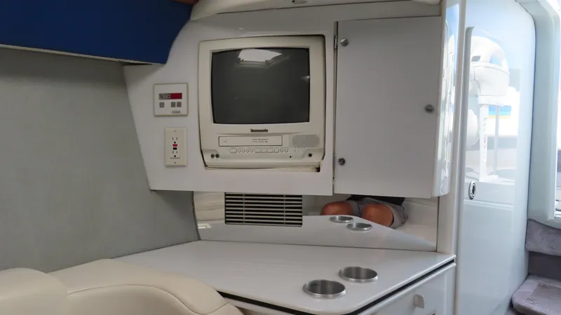 Slide: The Image of Interior of a 2000 Formula Fastech boat with vintage TV and storage cabinets. - 22