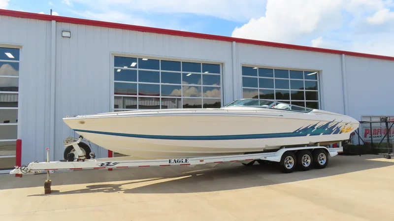 Slide: The Image of 2000 Formula Fastech boat on trailer outside a garage, side view. - 3