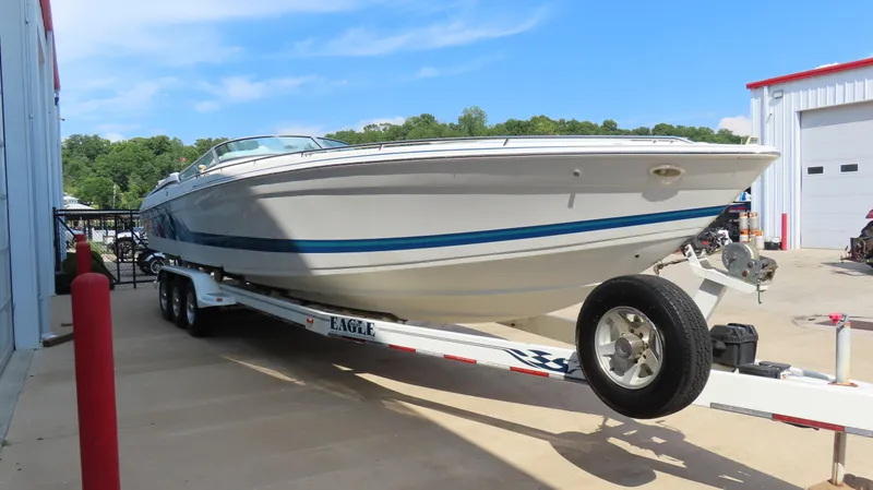 Slide: The Image of 2000 Formula Fastech boat on trailer, parked outdoors near a building. - 5