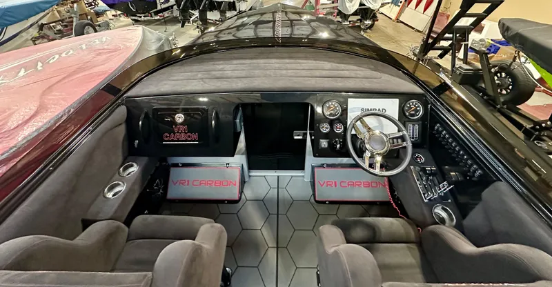 Slide: The Image of Interior of a 2022 Velocity VR1 boat featuring VR1 Carbon branding and modern controls. - 13