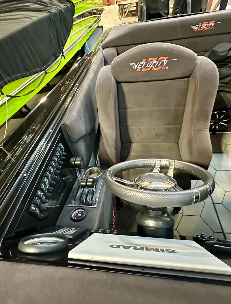 Slide: The Image of Interior of a 2022 Velocity VR1 boat with steering wheel and control panel. - 15