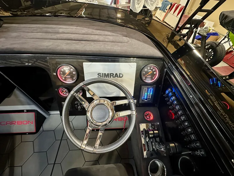 Slide: The Image of 2022 Velocity VR1 cockpit with Simrad display, modern controls, and sleek steering wheel. - 16