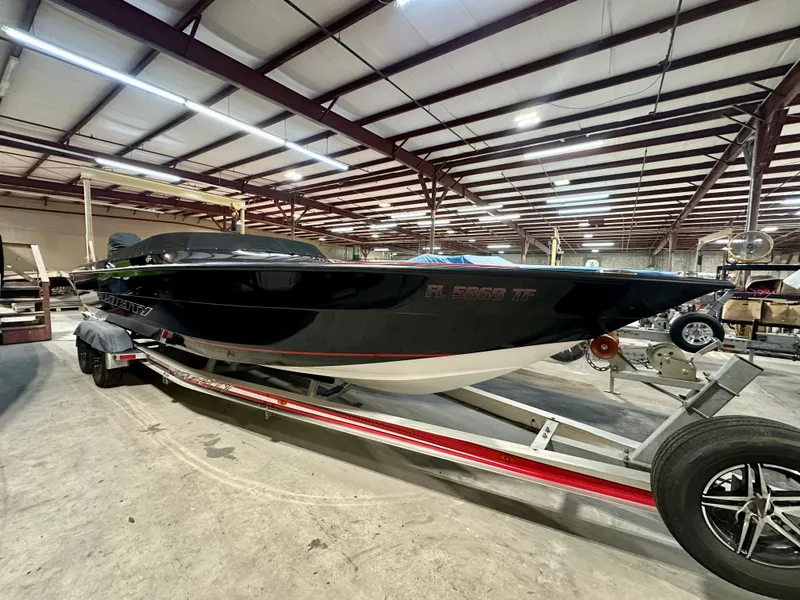 Slide: The Image of 2022 Velocity VR1 boat on trailer in warehouse setting. - 2