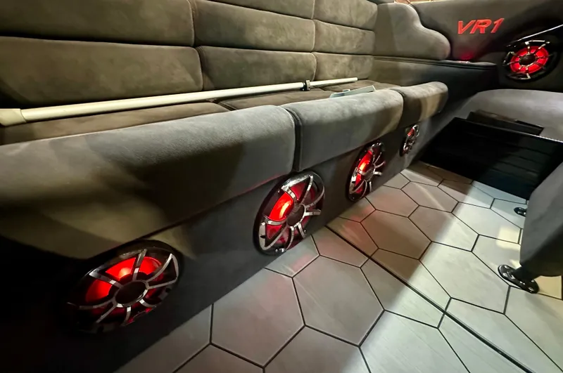 Slide: The Image of 2022 Velocity VR1 interior with red-lit speakers and hexagonal floor tiles. - 21