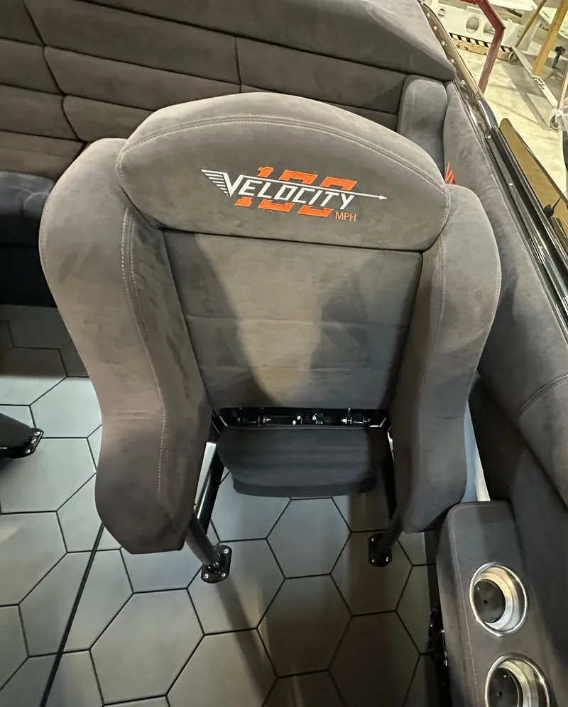 Slide: The Image of 2022 Velocity VR1 seat with logo, hexagonal floor tiles, and cup holders. - 26