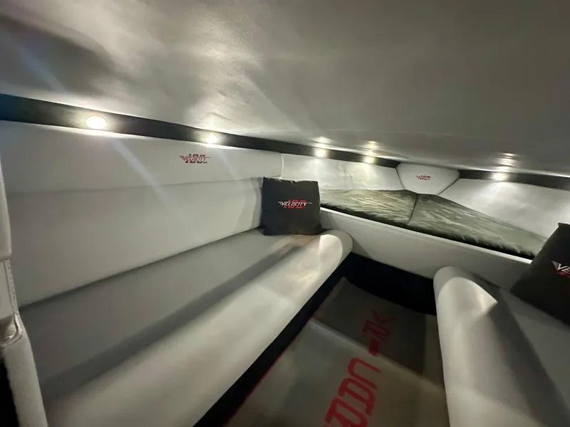 Slide: The Image of Interior of 2022 Velocity VR1 boat, featuring sleek seating and ambient lighting. - 32