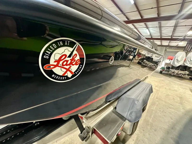 Slide: The Image of 2022 Velocity VR1 boat with "Dialed in at Lake Mercury Racing" decal in a warehouse. - 5