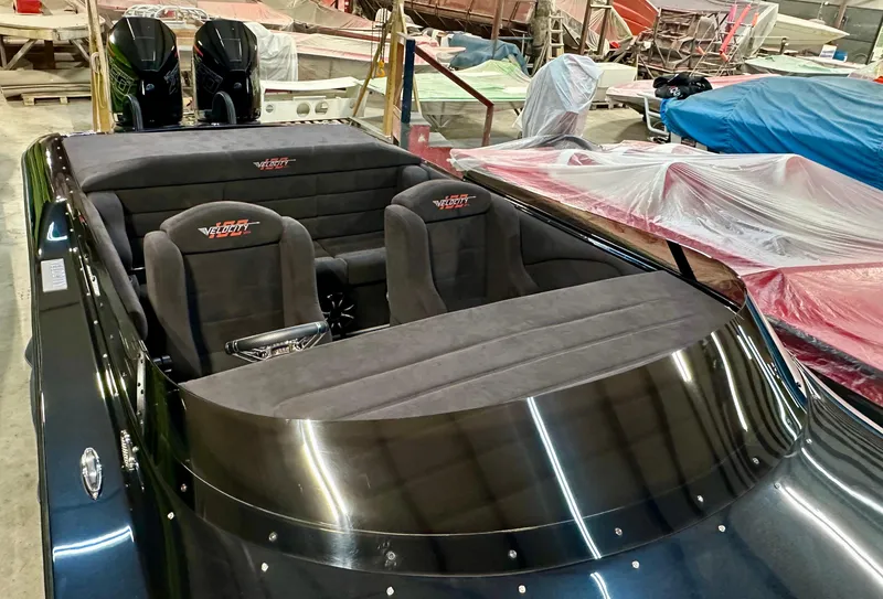 Slide: The Image of 2022 Velocity VR1 boat interior with plush seating and dual engines in a workshop setting. - 6