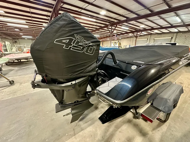 Slide: The Image of 2022 Velocity VR1 boat with covered outboard motor in a warehouse setting. - 7