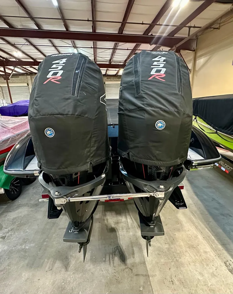 Slide: The Image of Twin Mercury 450R engines on a 2022 Velocity VR1 boat in a warehouse. - 9