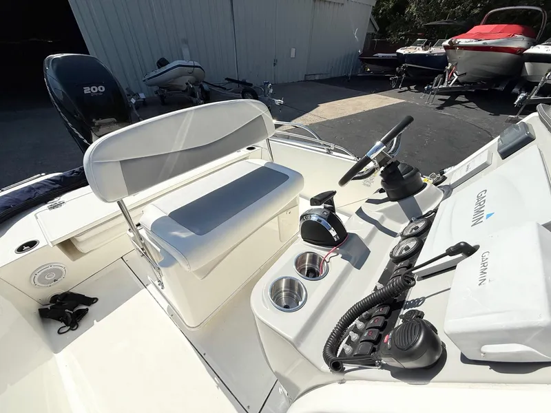 Slide: The Image of 2016 Boston Whaler 210 Dauntless boat interior with Garmin equipment and seating. - 6