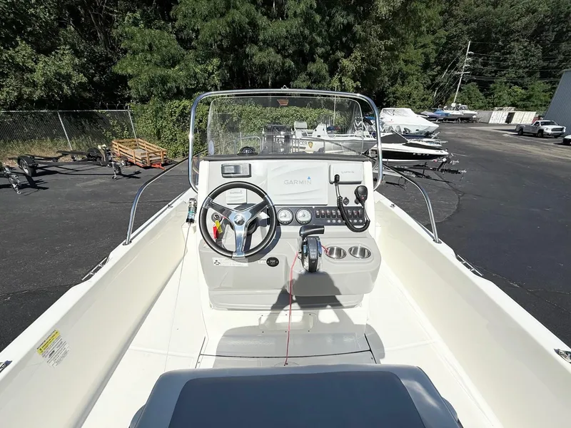 Slide: The Image of 2016 Boston Whaler 210 Dauntless boat cockpit with steering wheel and controls. - 7