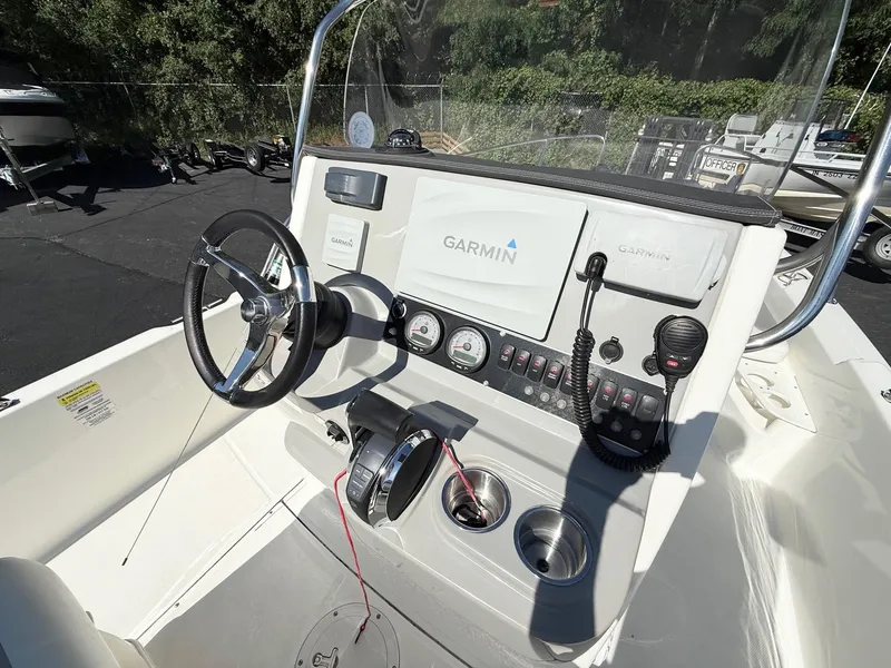 Slide: The Image of 2016 Boston Whaler 210 Dauntless boat console with Garmin navigation system and steering wheel. - 8