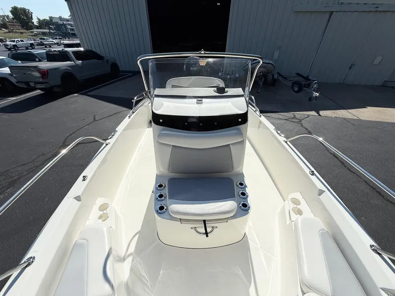 Slide: The Image of 2016 Boston Whaler 210 Dauntless boat interior with seating and cup holders. - 9