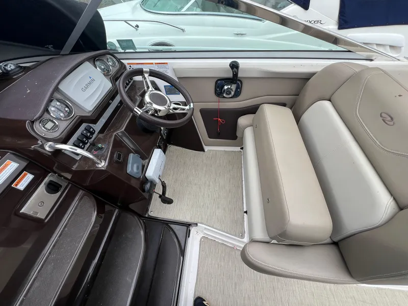Slide: The Image of Interior cockpit of 2015 Regal 28 Express boat with steering wheel and seating. - 10