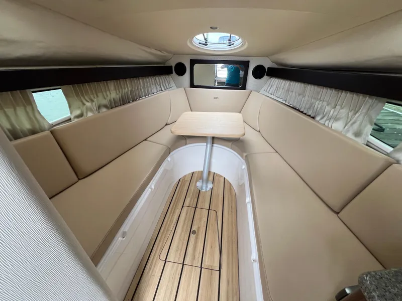 Slide: The Image of 2015 Regal 28 Express cabin interior with beige seating and wooden flooring. - 17