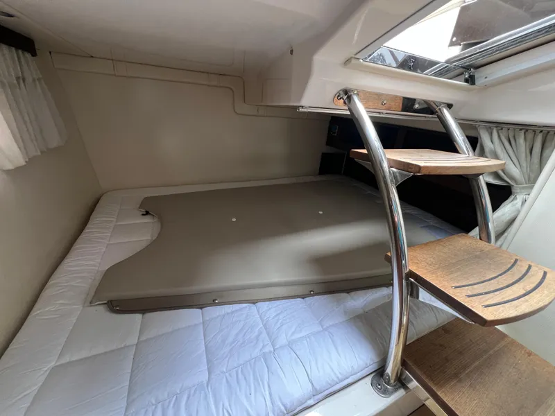 Slide: The Image of Interior cabin of 2015 Regal 28 Express boat with bed and wooden steps. - 22