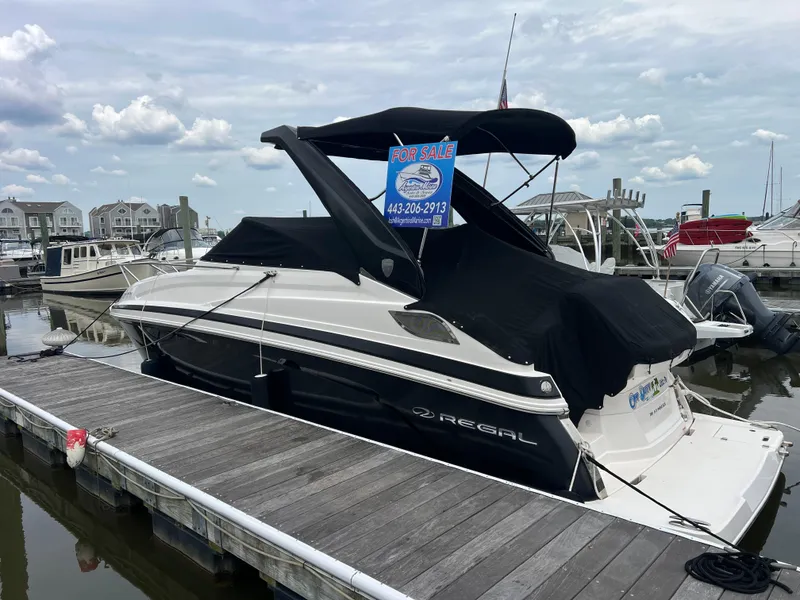 Slide: The Image of 2015 Regal 28 Express boat docked, covered, and for sale at a marina. - 25