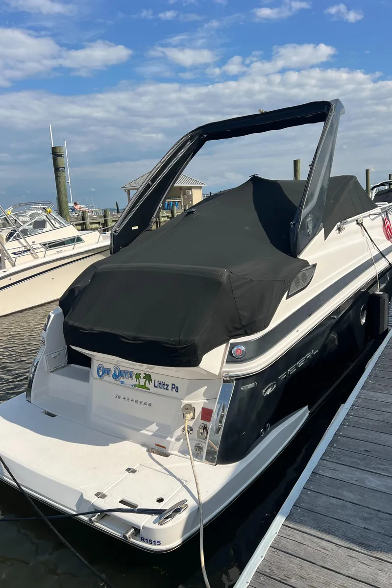 Slide: The Image of 2015 Regal 28 Express boat docked at marina under clear blue sky. - 26