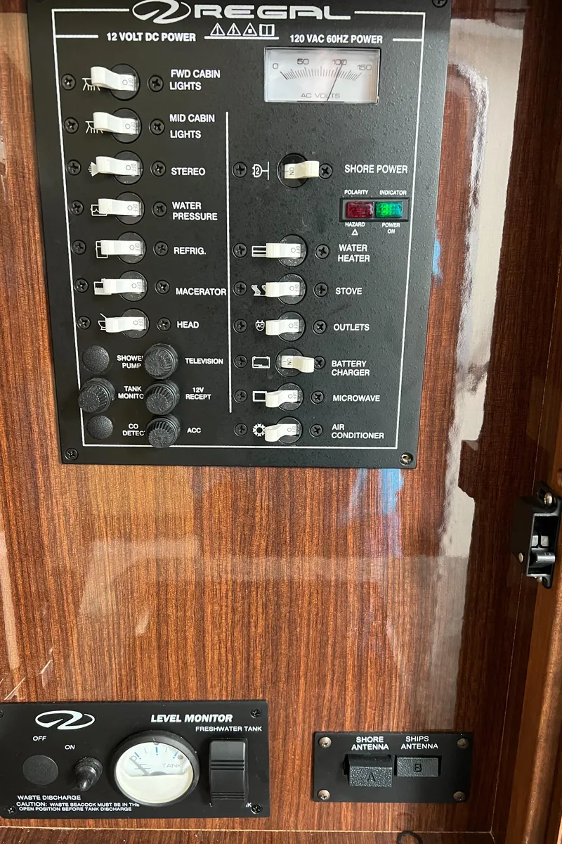 Slide: The Image of Control panel of a 2015 Regal 28 Express boat with various switches and indicators. - 29