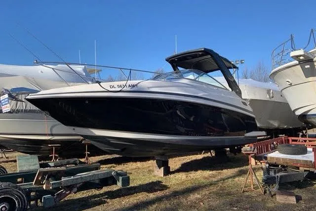 Slide: The Image of 2015 Regal 28 Express boat on display outdoors, clear sky background. - 31