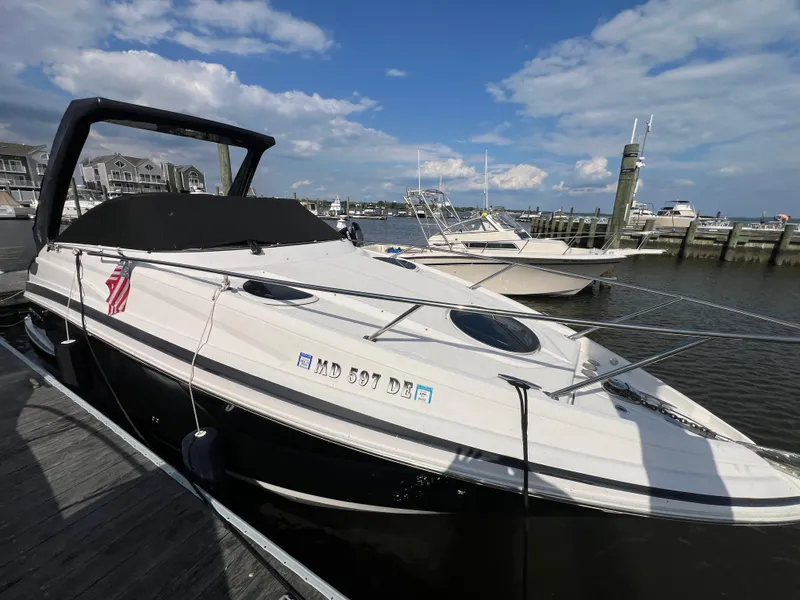Slide: The Image of 2015 Regal 28 Express boat docked at marina under blue sky. - 4