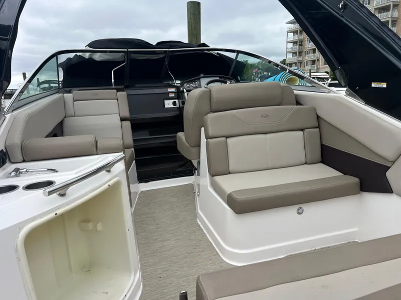 Slide: The Image of 2015 Regal 28 Express boat interior with beige seating and modern dashboard. - 6