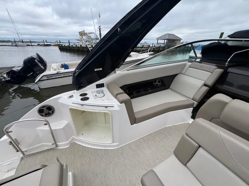 Slide: The Image of 2015 Regal 28 Express boat interior with seating, docked by the water. - 8