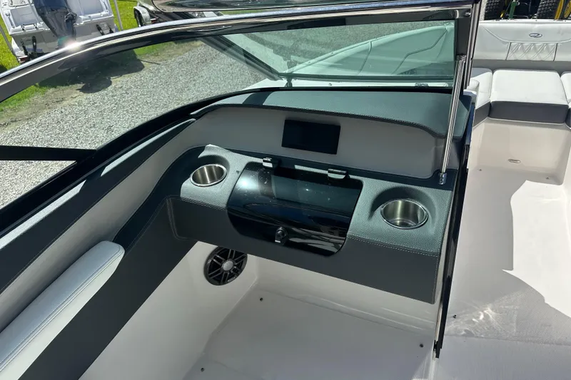 Slide: The Image of 2024 Regal LX4 boat on trailer, parked outdoors near dealership. - 2