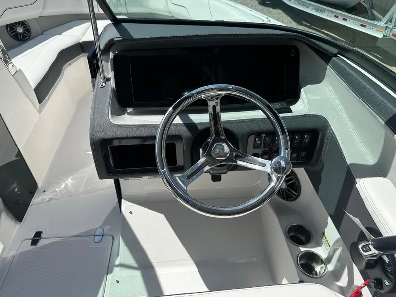 Slide: The Image of 2024 Regal LX4 boat on trailer under clear blue sky. - 3