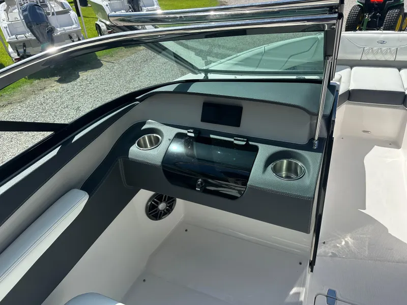 Slide: The Image of 2024 Regal LX4 boat interior with cup holders and seating area. - 4