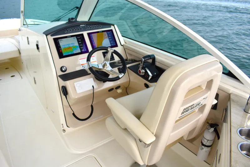 Slide: The Image of 2023 Boston Whaler 320 Vantage helm with modern controls and navigation displays. - 11