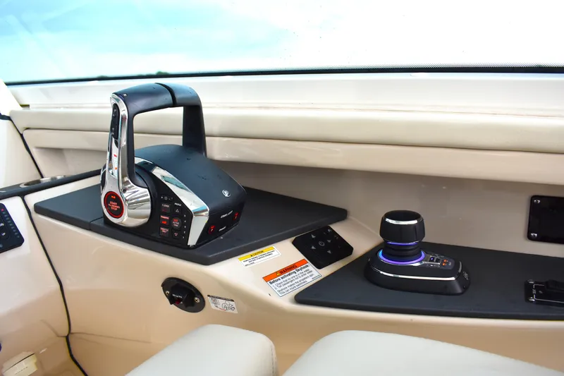 Slide: The Image of 2023 Boston Whaler 320 Vantage helm controls with joystick and throttle. - 13