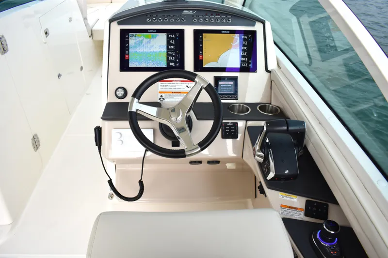Slide: The Image of 2023 Boston Whaler 320 Vantage helm with advanced navigation displays and controls. - 14