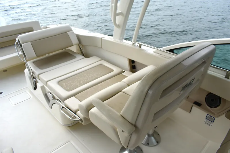 Slide: The Image of 2023 Boston Whaler 320 Vantage boat interior with adjustable seating near water. - 17