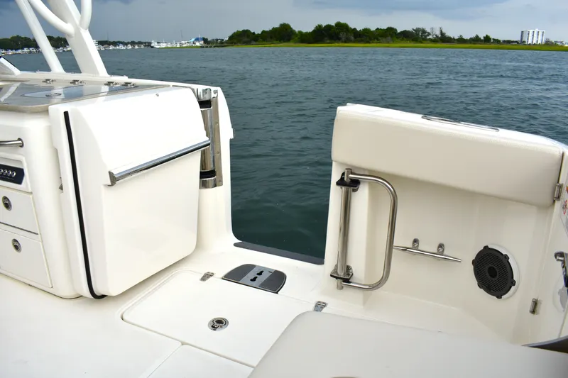 Slide: The Image of 2023 Boston Whaler 320 Vantage boat interior, featuring sleek white seating and stainless steel accents. - 24