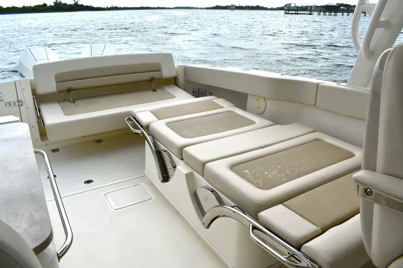 Slide: The Image of 2023 Boston Whaler 320 Vantage boat interior with comfortable seating and scenic water view. - 25