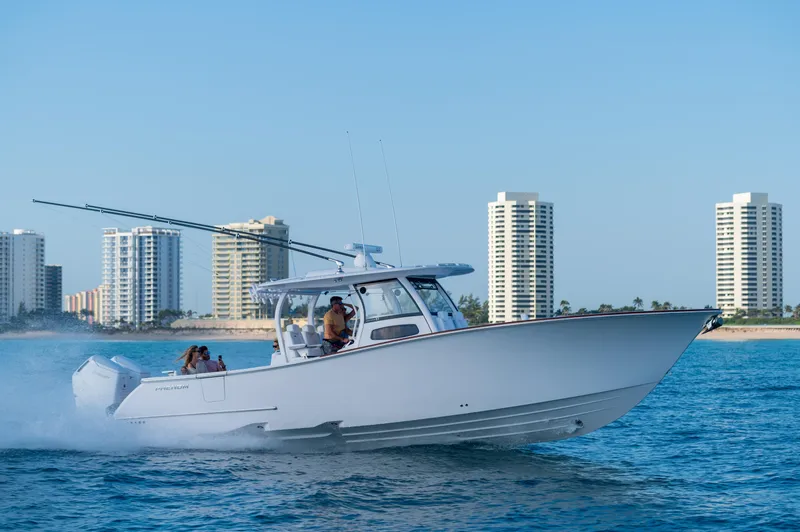 Slide: The Image of 2026 Phenom 37 Center Console boat cruising near city skyline. - 1