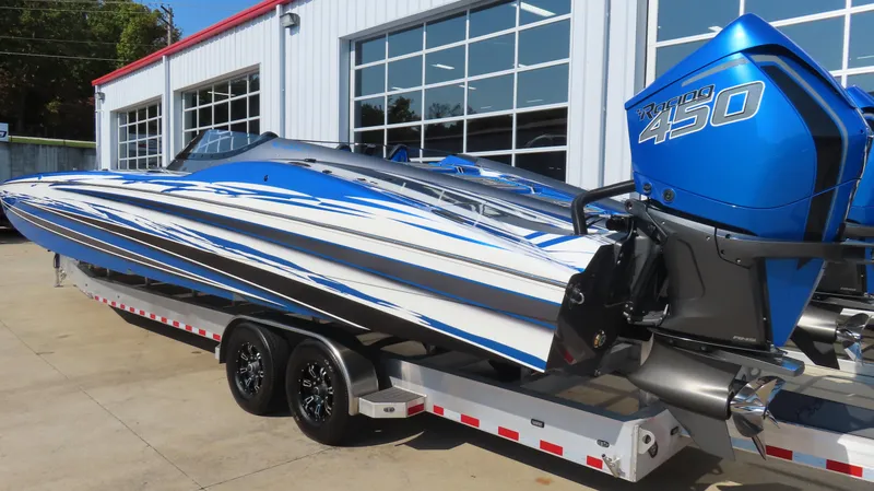 Slide: The Image of 2023 MTI 390X powerboat with blue and white design on a trailer. - 11