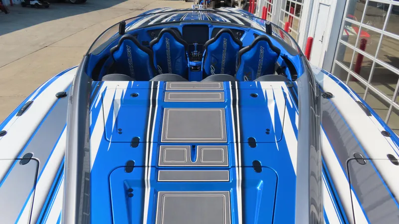 Slide: The Image of 2023 MTI 390X speedboat with blue and white design, featuring sleek seating and modern detailing. - 12