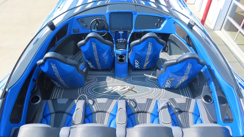 Slide: The Image of Interior of 2023 MTI 390X boat with blue seating and modern dashboard. - 16
