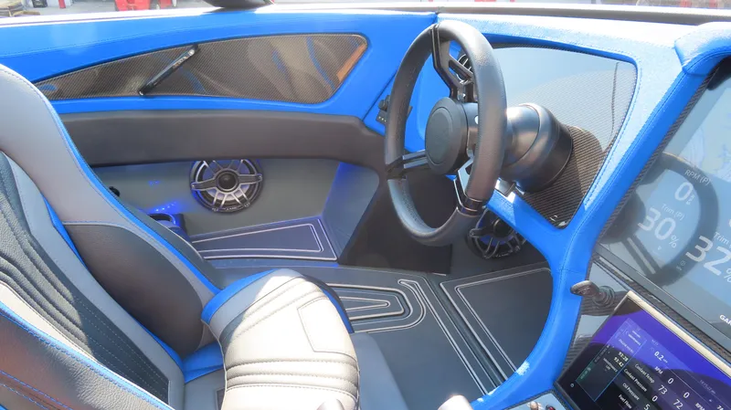 Slide: The Image of 2023 MTI 390X interior with blue accents, modern dashboard, and sleek steering wheel design. - 19